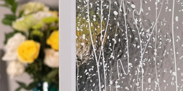 Mistify doorglass in front of a bouquet of flowers